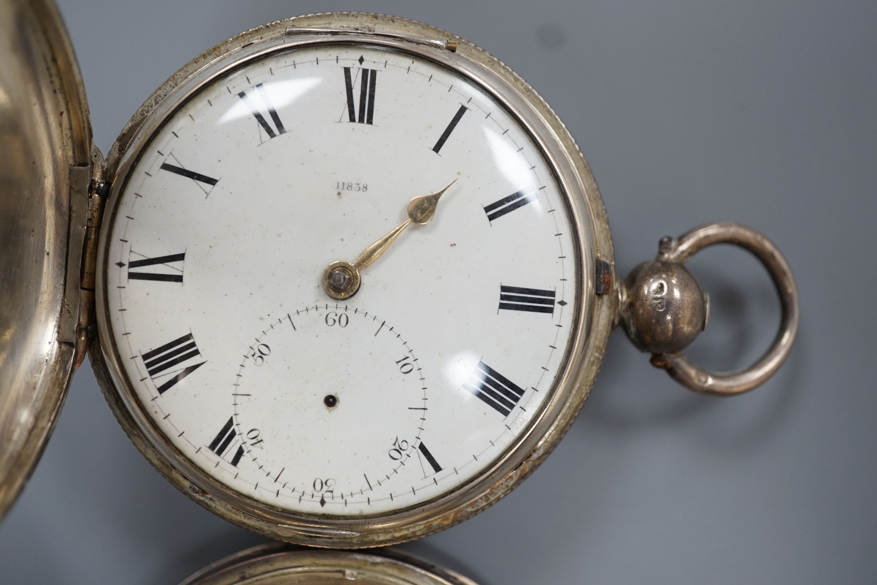 A 19th century white metal hunter pocket watch, by Robert Roskell, Liverpool, engraved with train on a bridge and one other silver hunter pocket watch.